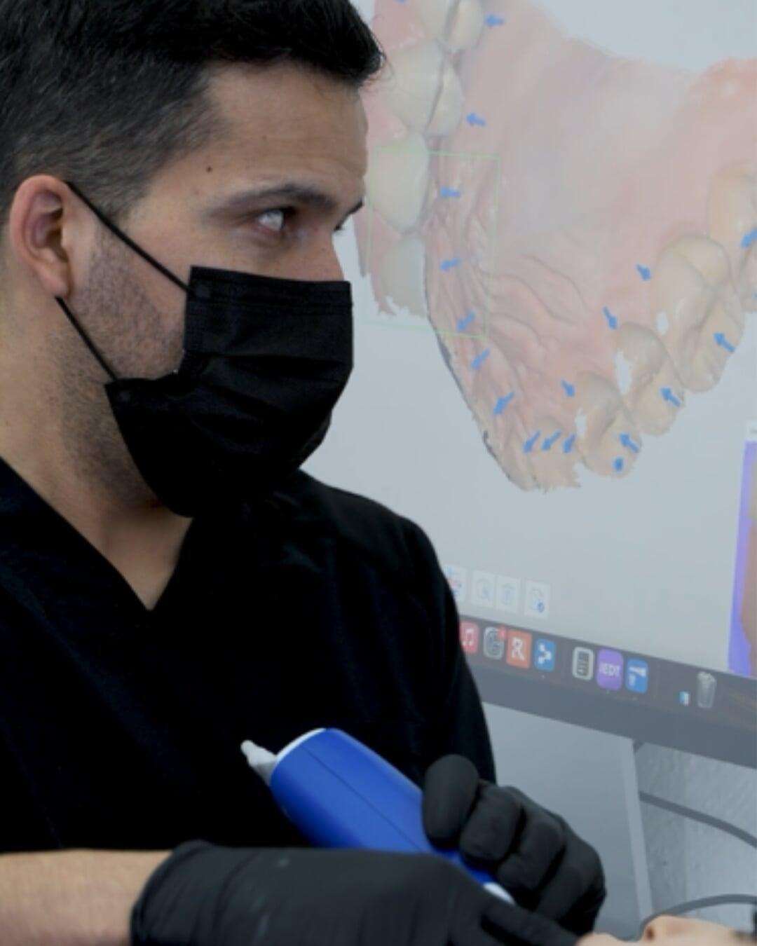 Dr. David Martinez scanning a patient with an intraoral scanner at EnamelDent Tijuana
